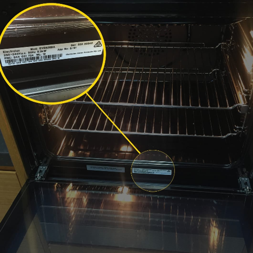 Example serial / model number plate inside the oven door, magnified to show the manufacturer label