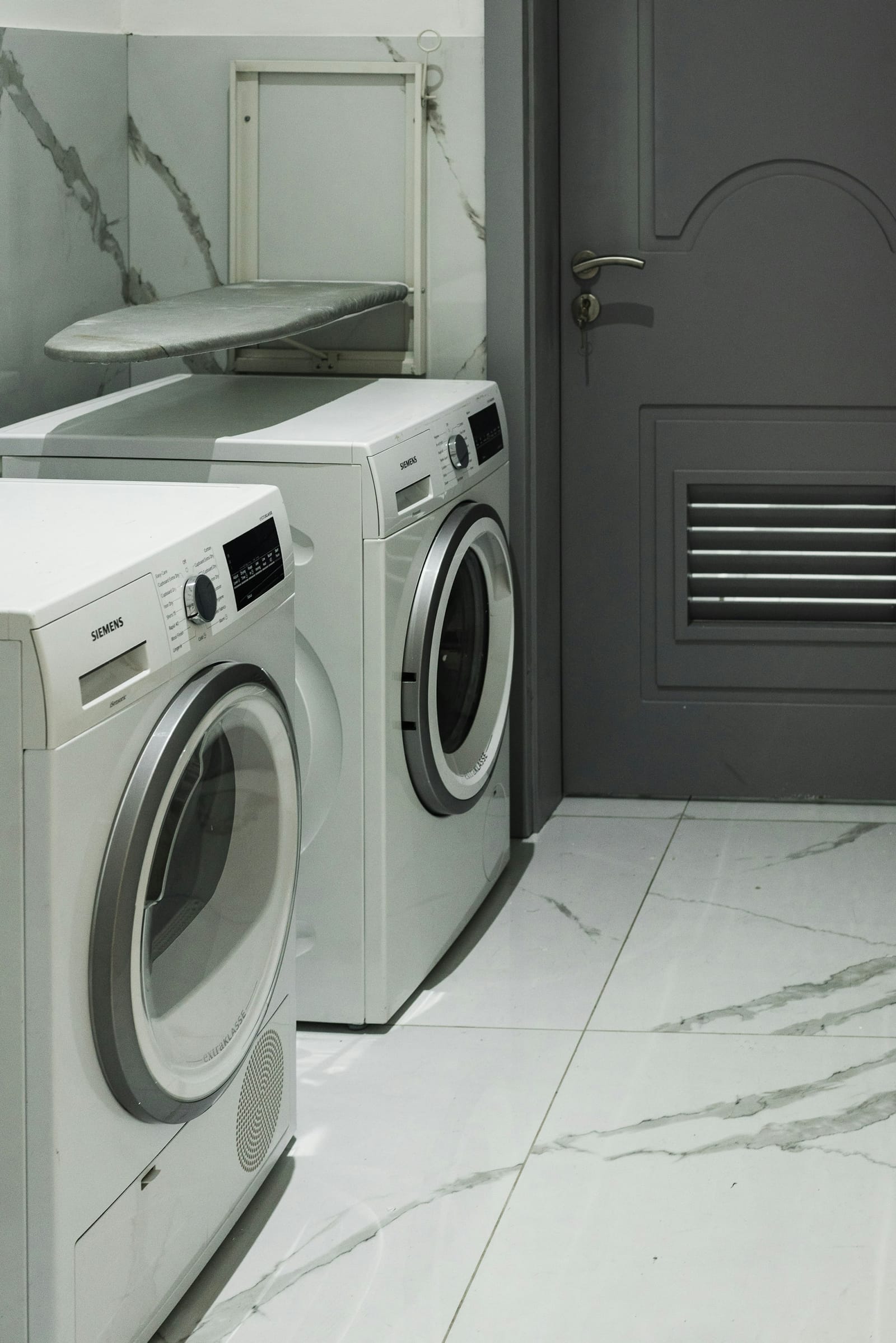 Modern front-loader washing machine in a laundry